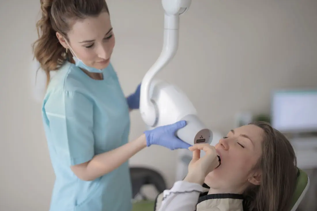 A dentist working with a patient in a clinic