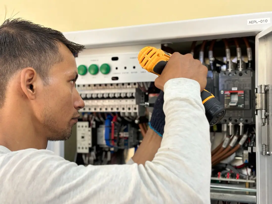 An electrician working on a job