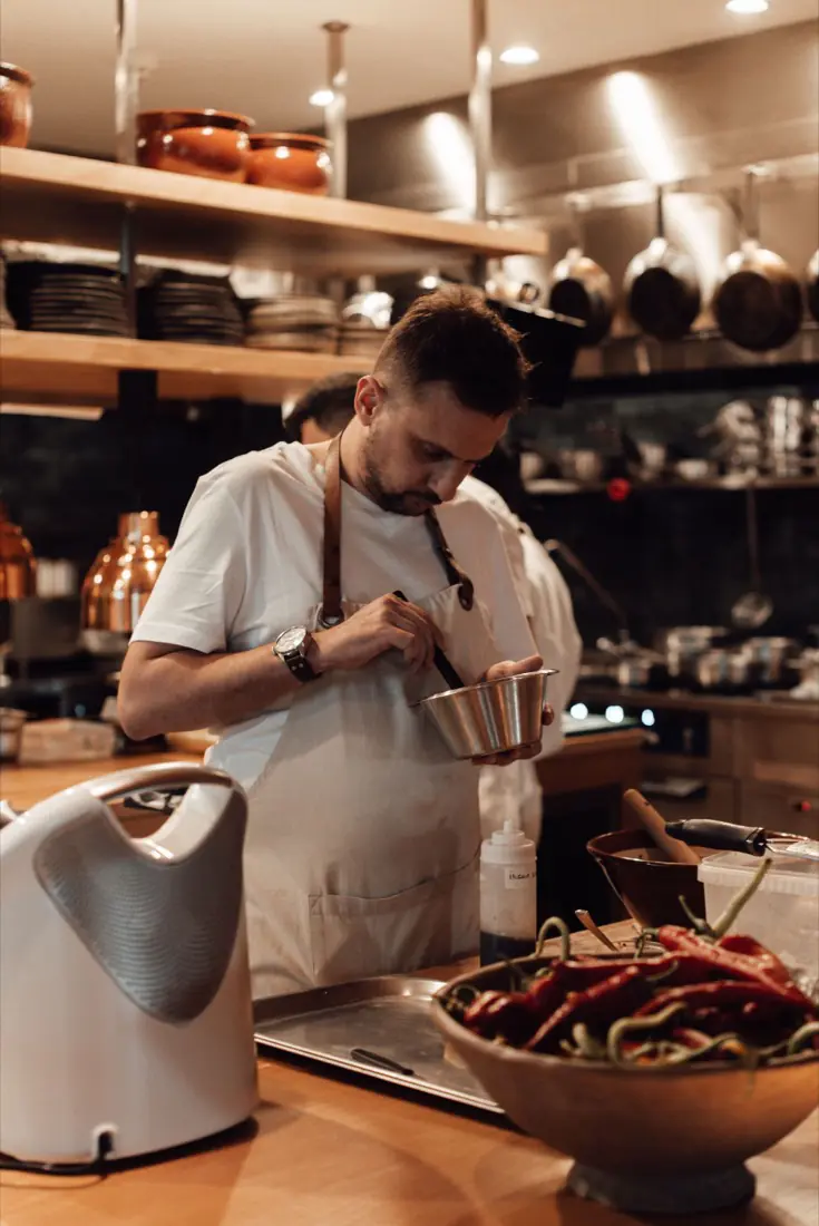A chef preparing food in a restaurant kitchen